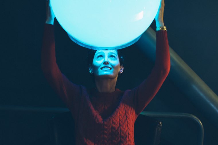 Woman holding a light over her head