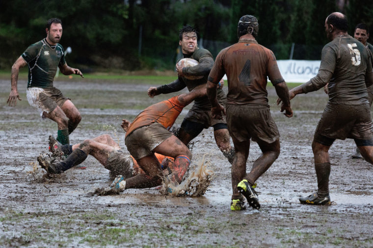 Men in a rough, muddy rugby match